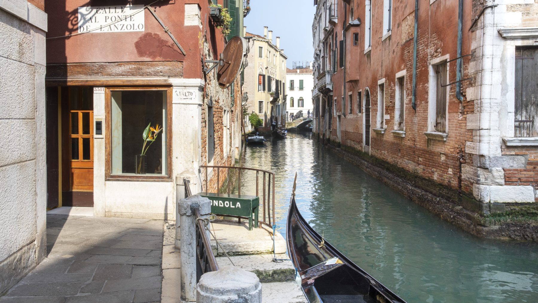 Hotel Riva canal entrance in Venice with moored gondola, 'Calle al Ponte' sign, and historic facade - Hotel Riva, BZAR hotels in Venice