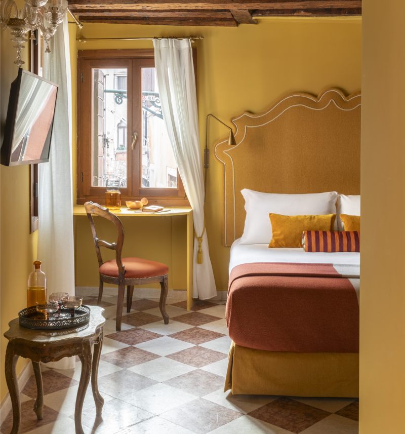 Sunny mustard yellow hotel triple room with rustic wooden beams and canal view window - Hotel Riva, BZAR hotels in Venice